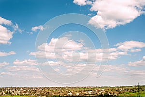 Village with houses on the horizon on a background of beautiful sky