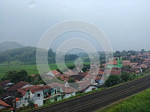 A village and houses view next to the railroads