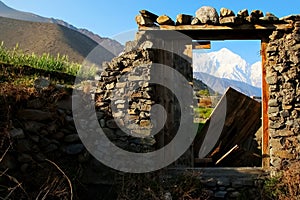 The village Kagbeni in the Himalayan mountains. Mountain View through a doorway. Nepal