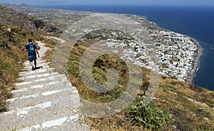 The village of Kamari in the island of Santorini, Greece, seen from way above at the entrance of the Ancient Village of Thera in a