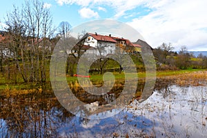 Village of Laze pri Gorenjem Jezeru and a reflection of the buildings