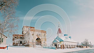 Village Lenino, Dobrush District, Gomel Region, Belarus. Old Ruined Orthodox Church Of The St. Nicholas Near New Church