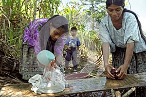 Village life Indian mother and daughter wash laundry