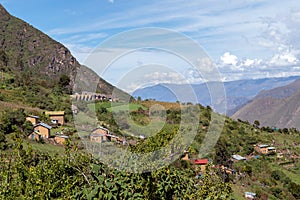 Village of Marampata at green Peruvian mountains, Apurimac river valley with bkue sky, Peru photo