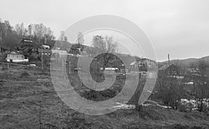 Village in the mountains in winter, black and white photo