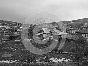 Village in the mountains in winter, black and white photo