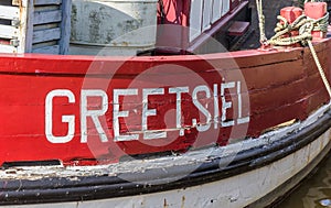 Village name on a red wooden fishing boat in Greetsiel