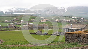 Village near border between Armenia and Georgia. Oven chimney smokes overcast