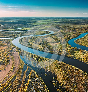 Village Near River, Aerial View Green Forest Woods And River Landscape In Sunny Spring Summer Day. Top View Of