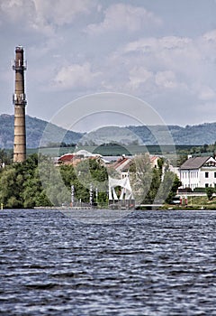 Village of Nucnice above Labe river with tall factory chimney