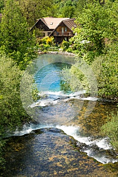 Village of Rastoke by a Korana river with wooden houses and a waterfall, Croatia