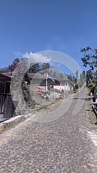 village Road stone home and sky