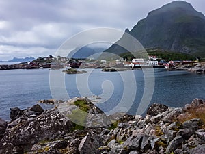 A village on the rocky shore of the fjord in Norway