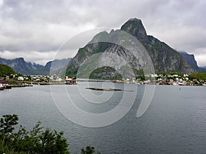 A village on the rocky shore of the fjord in Norway