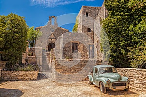 Village of Saignon with old car against church in the Luberon, Provence, France