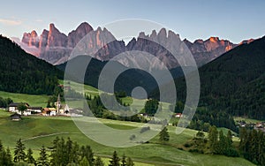 Village of Santa Magdalena and church on the Italian mountains Dolomites Alps at sunrise, Italy