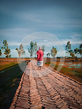 A village sceninc route with a walking man photo