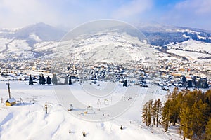 Village in snow mountains after blizzard, aerial landscape. Mountaneering concept
