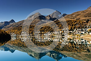 Village of St. Moritz in Switzerland with fall color reflections and mountain landscape photo