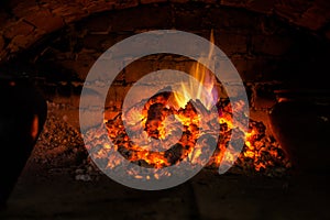 Village stove firewood and fire. Burning wood inside traditional oven