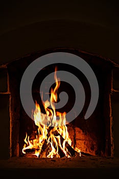 Village stove firewood and fire. Burning wood inside traditional oven.