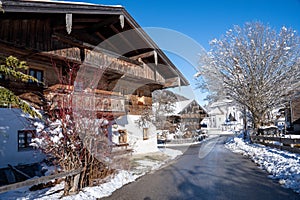 Village street of the mountaineering village of Sachrang in Chiemgau, Bavaria, Germany in winter photo