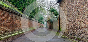 Village street scene taken in wide angle showing ancient brick walls converging