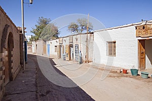 Village street in between stone houses in San Pedro de Atacama, Chile photo