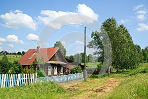 Village street in summer. Beautiful log house. Village of Visim, Sverdlovsk region, Russia