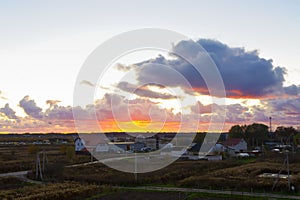 Village in the sun, sunset over the fields