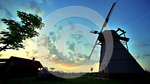 Village sunrise timelapse. Rural windmill silhouette. Sunrise landscape
