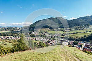 Village under hills and blue sky