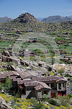 Village under Pinnacle Peak with McDowell Mountain range in the