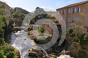 Village with waterfall, Provence, France.