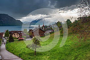 Village Weggis on Lucerne lake under dramatic clouds, Switzerland