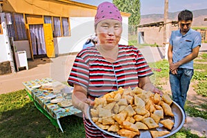 Village woman cooked national Kyrgyz bread