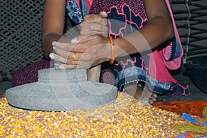 A village woman`s hand, grinds gram in an old hand operated flour mill