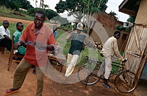 Villagers dancing to music, Uganda