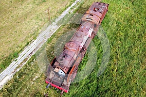 Villarcayo, Spain - June 10, 2020: Old train cemetery. Aerial view of an old abandoned rusty steam train. photo
