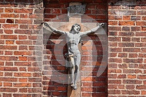 Vilnius, Lithuania - August 19, 2017: Crucifixion of Jesus Christ on brick wall of Catholic Church st. Anne in Vilnius.