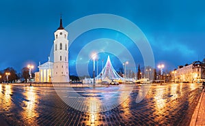 Vilnius, Lithuania. Christmas Tree On Background Bell Tower Belfry Of Vilnius Cathedral At Cathedral Square In Evening