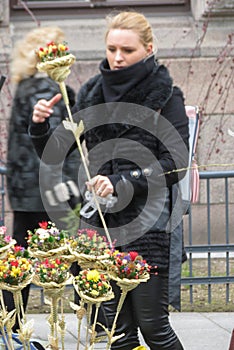 Blonde girl selling flower bouquets