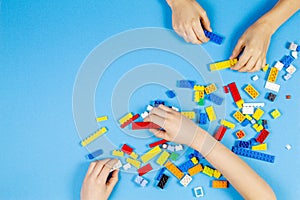 Vilnius, Lithuania - February 23, 2019. Children hands play with colorful lego blocks on the table