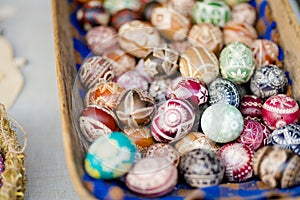 VILNIUS, LITHUANIA - MARCH 4, 2022: Colorful handmade wooden Easter eggs sold in annual traditional crafts fair in Vilnius