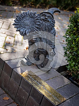 A bronze dwarf Zyczliwek statue in Bernardine Garden, Vilnius, Lithuania.