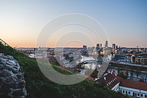 Vilnius modern financial district panorama at dusk from Gediminas tower with Neris river running in between