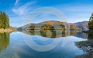 Vilshany water reservoir on the Tereblya river, Transcarpathia, Ukraine. Picturesque lake with clouds reflection. Beautiful autumn photo