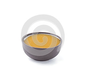 Vinaigrette sauce in brown bowl isolated