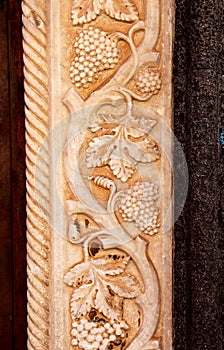 vine plant with clusters of grapes, bas-relief
