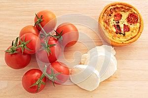 Vine tomatoes, mozzarella, and a tomato and mozzarella tartlet photo